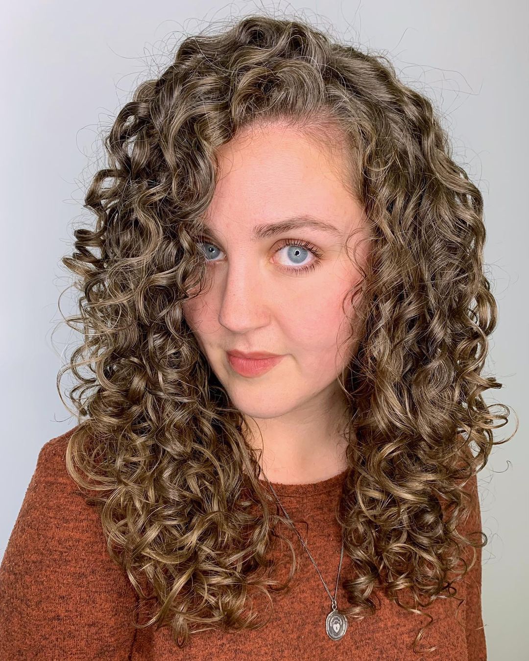 Long curly hair with a side part