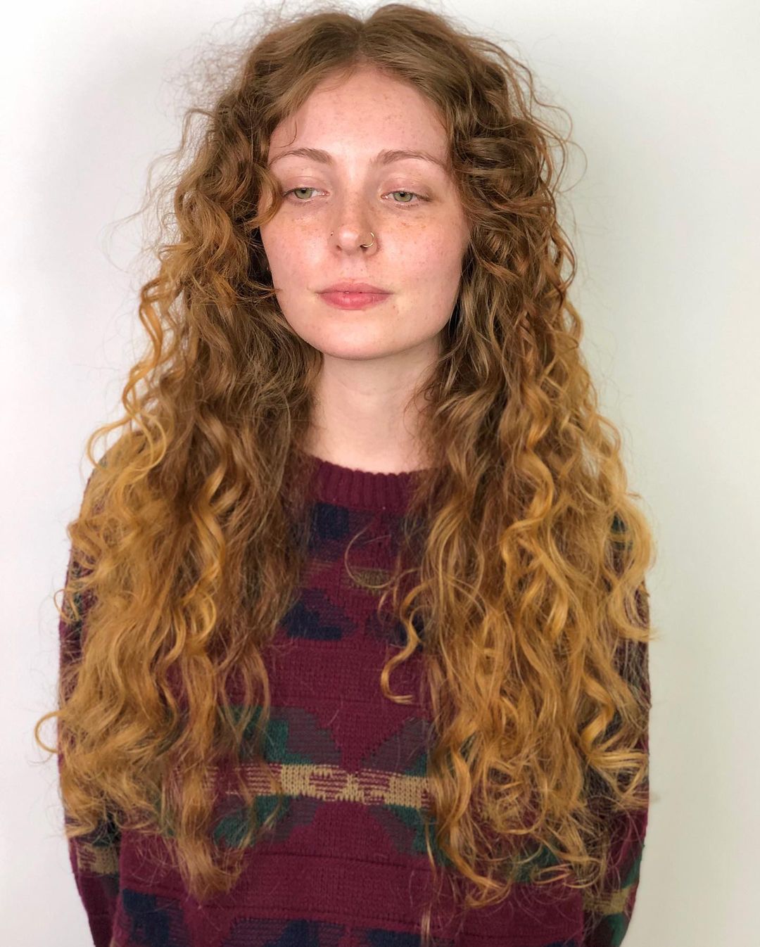 Extra-long layered curly hair with a center part