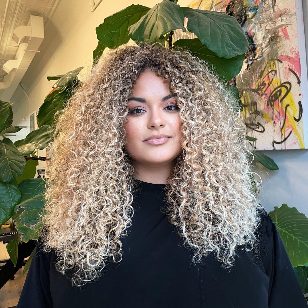 Long pale blonde curly hair with volume