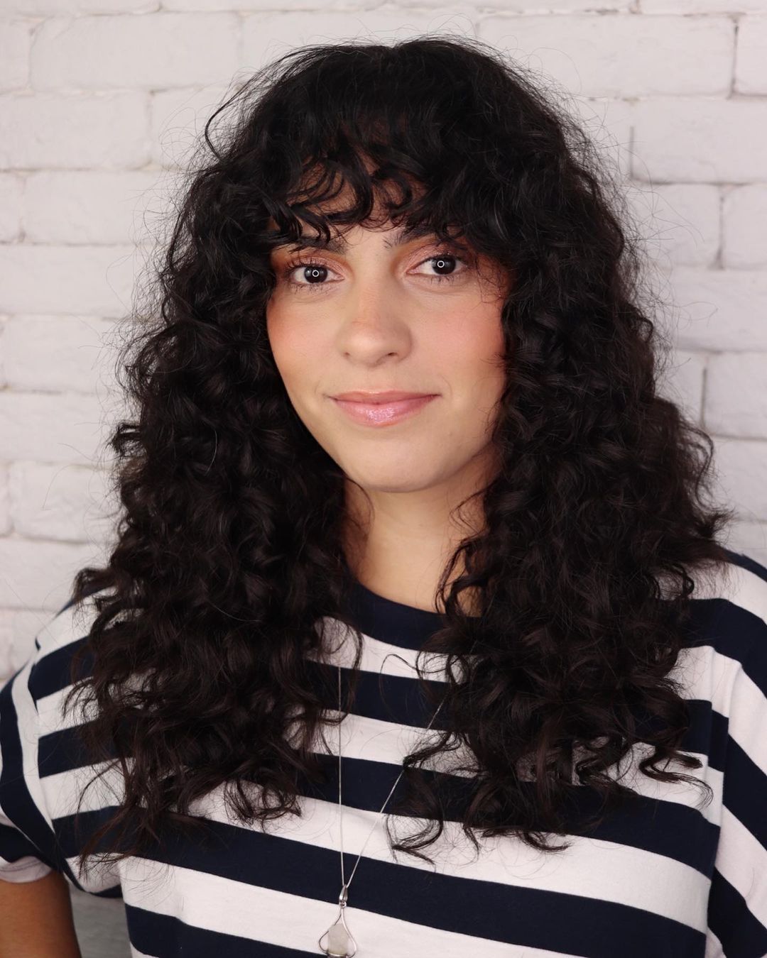 Long curly hair with a curly fringe