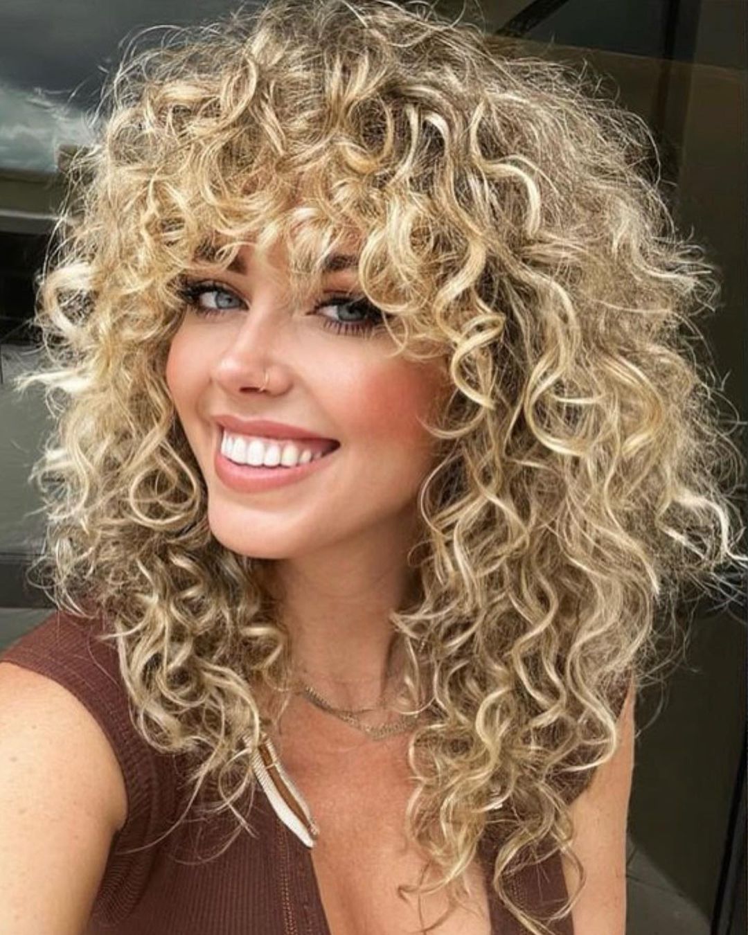 Long permed shag with butter blonde highlights