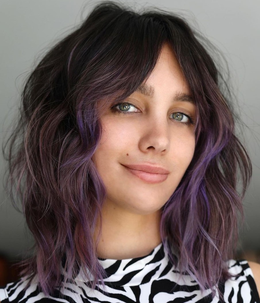 Wavy bob with soft pastel highlights and curtain bangs