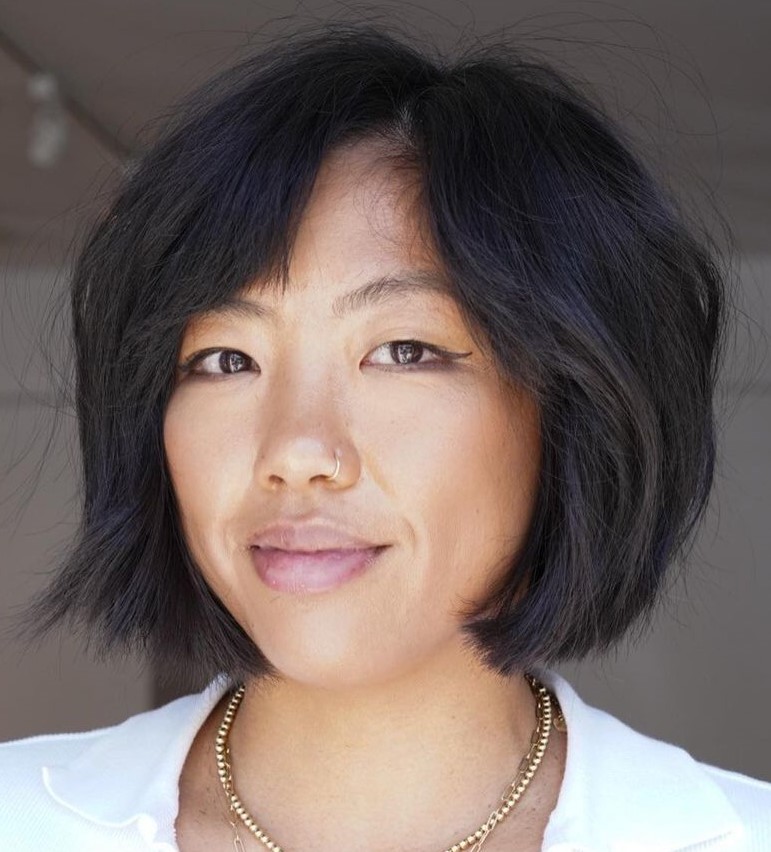 Chin-length bob worn with a deep side part and curtain bangs