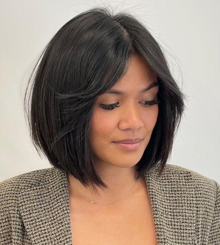 Rounded bob with layered curtain bangs