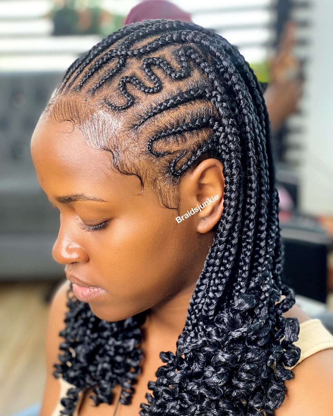 Cornrows to the back with a small heart-shaped braid design at the temple