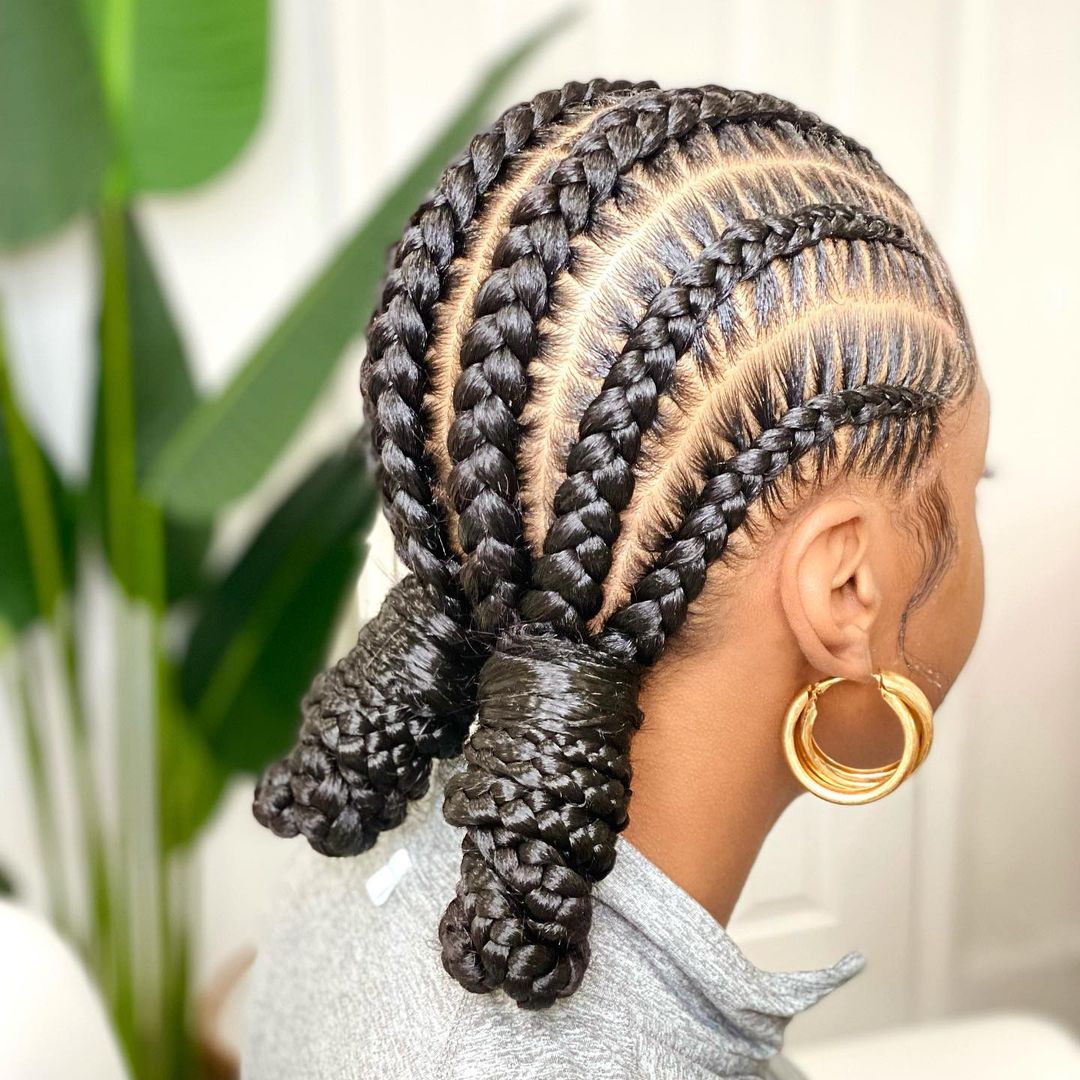 Stitch braids to the back wrapped into two low buns