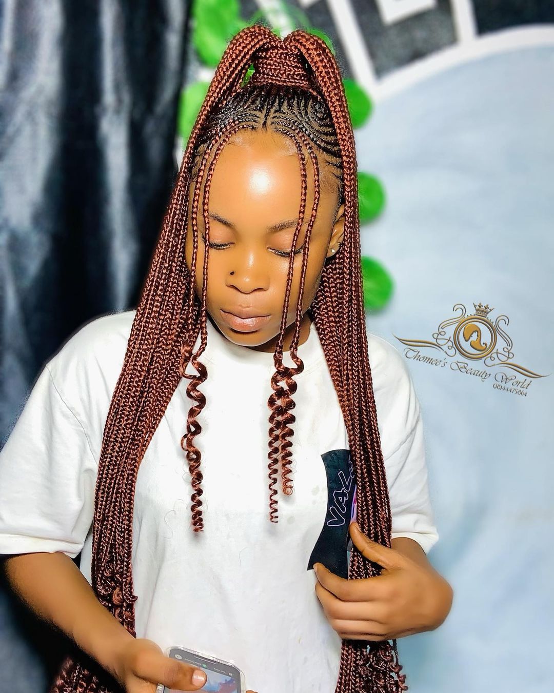 Straight-back cornrows gathered into a high ponytail with auburn feed-in braids