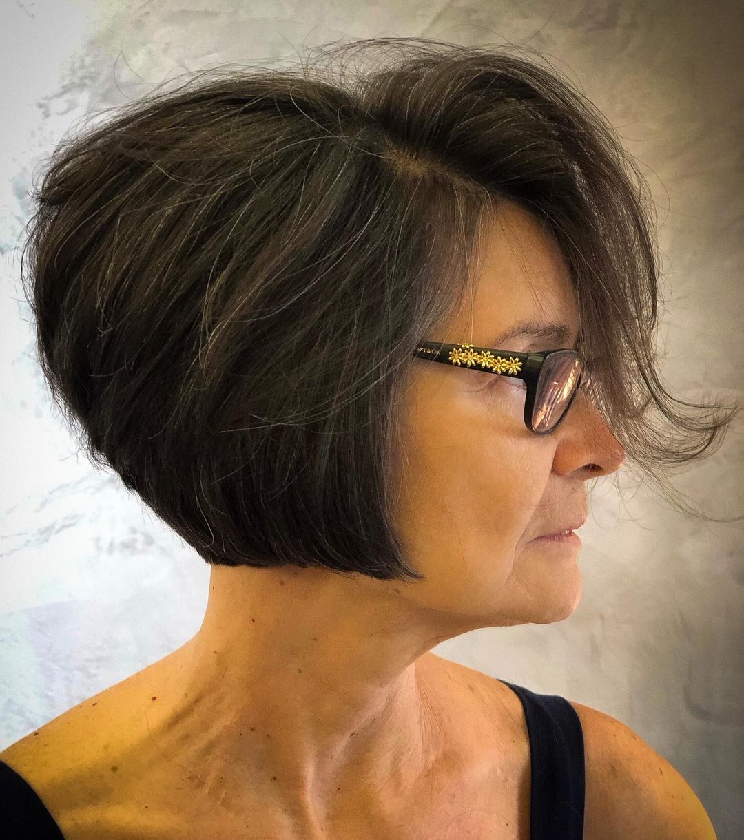 Stacked Brown Pixie Bob with Swoopy Bangs over Glasses