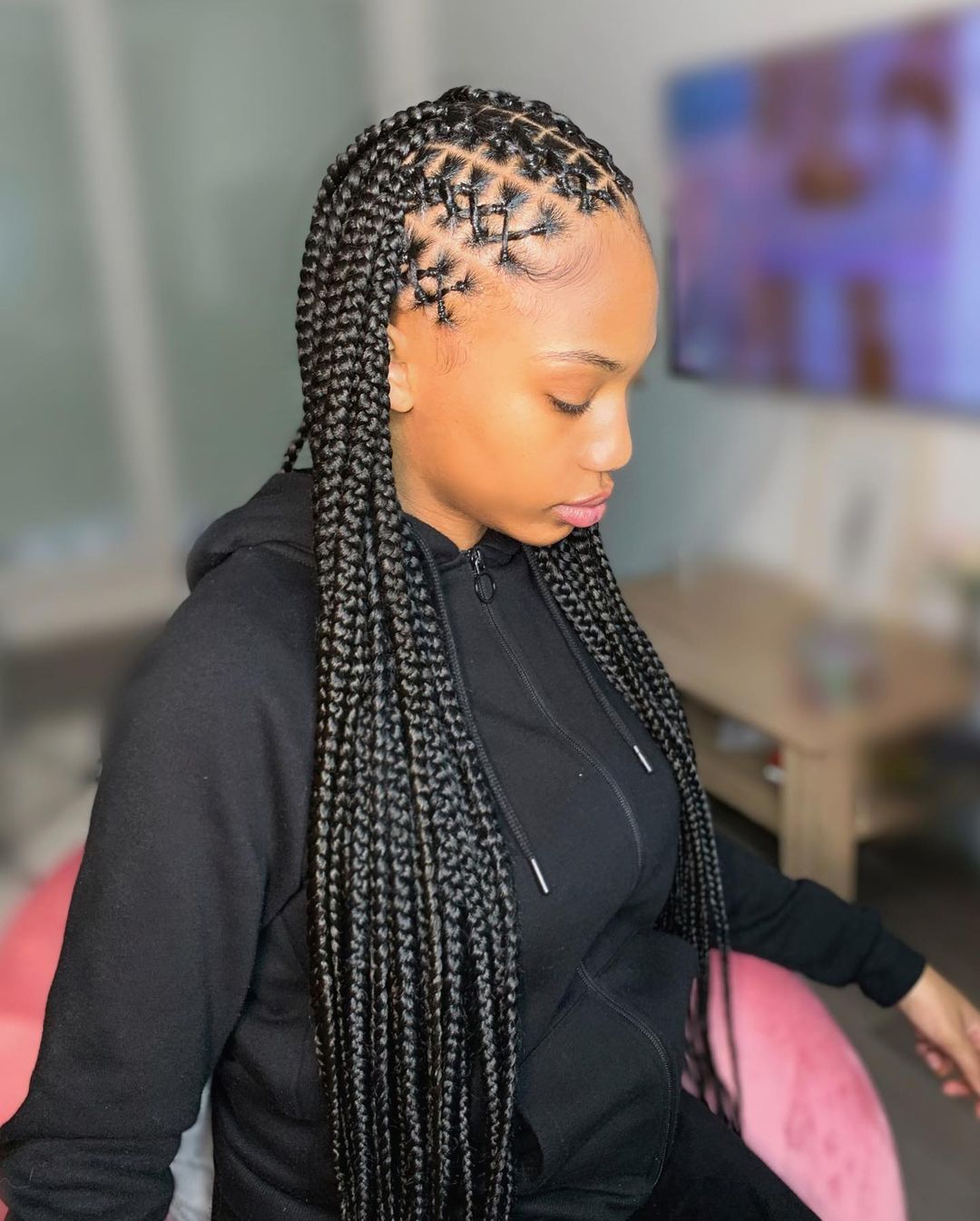 Criss-cross cornrows flowing into delicate braids worn to the back