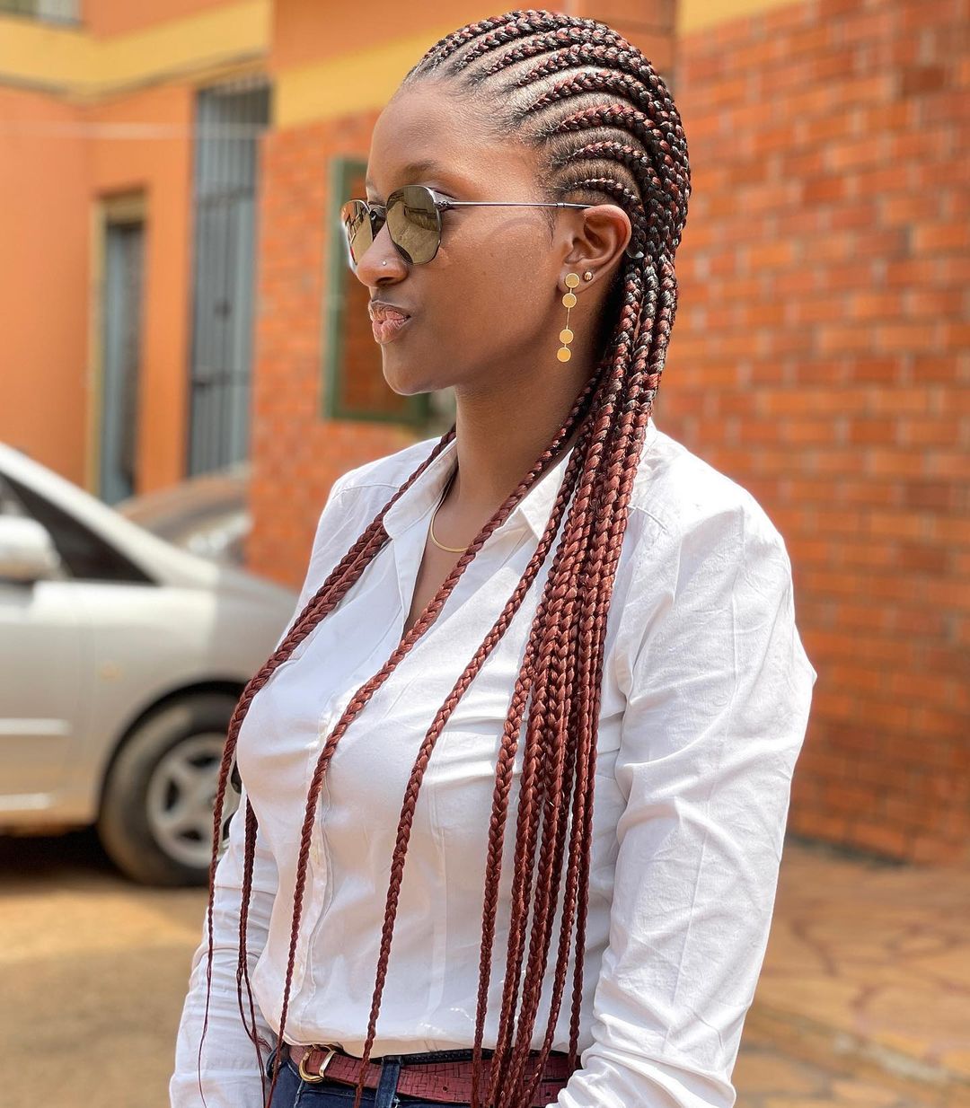 Thin straight-back cornrows with colourful feed-in extensions