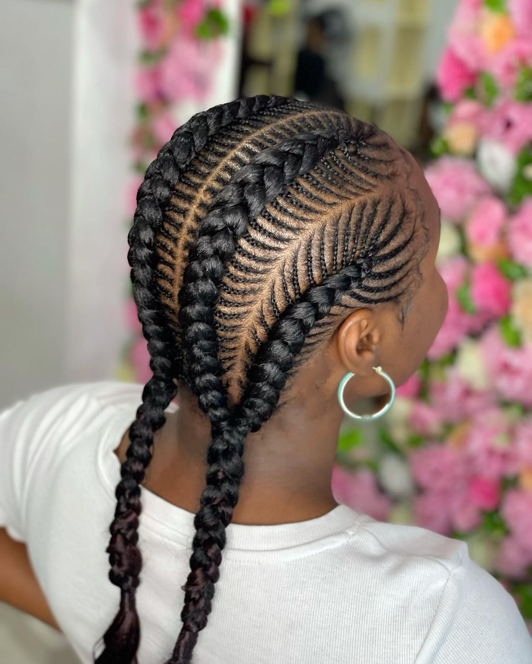 Four cornrows to the back crossed by many tiny braids in a millipede pattern