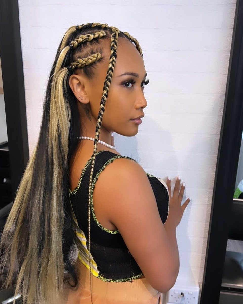 Blonde feed-in braids to the back with two braids framing the face
