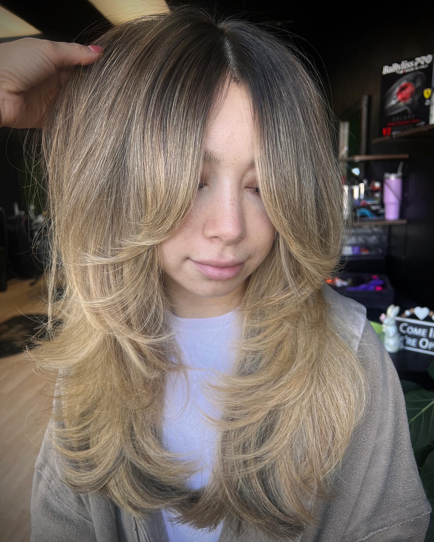 Long Blonde Layered Hair with Dark Roots